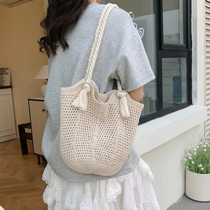 Handwoven hollow crochet tote bag with thick rope handles and tassels for summer