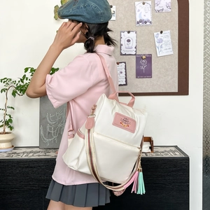 Minimalist vintage style beige backpack with colorful stripes and tassel for women