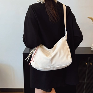 Large white hobo shoulder bag with stylish woven tassel details for summer casual wear