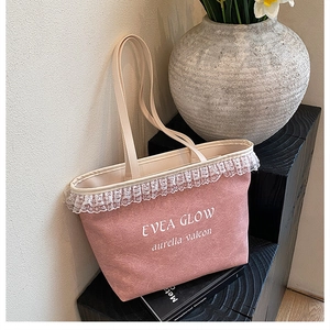 Detailed shot of pink tote bag featuring delicate white lace trim and minimalist lettering