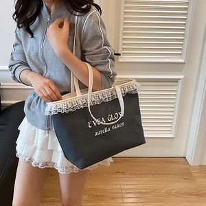 Chic black canvas tote bag with white lace trim and text print for women's daily use