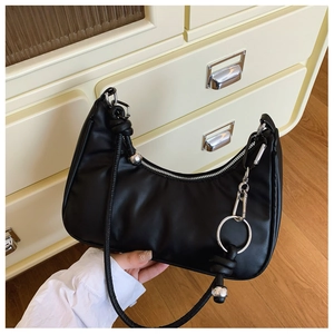 Detail of black leather crescent bag with silver hardware and knotted metallic strap