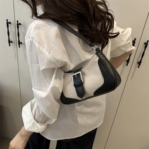 Chic retro patchwork underarm bag in cream canvas and black leather with silver buckle