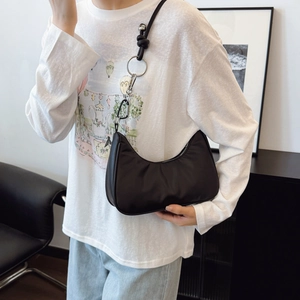 Minimalist black nylon crescent shoulder bag with silver metal ring and snap hook strap