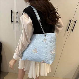 Light blue tote bag with butterfly embroidery and diamond quilted pattern for women
