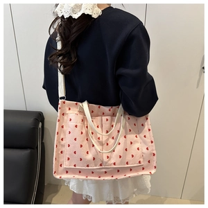 Pink corduroy tote bag with red heart patterns showing the large capacity and pockets