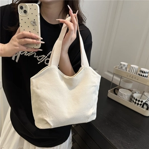 Minimalist off-white canvas tote bag for women shown in a cozy home setting for daily use