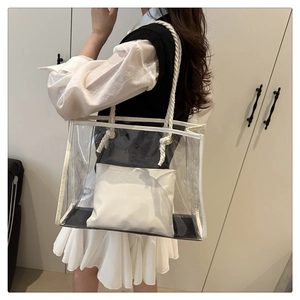Detailed view of clear PVC tote bag with white cotton rope handles and inner pouch