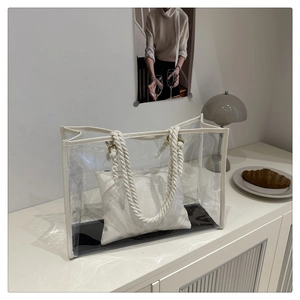 Detailed view of clear PVC tote bag with thick cotton rope handles and fabric inner pouch