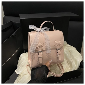 Pink PU leather backpack with bow embossing and lace ribbon detail in a gift box