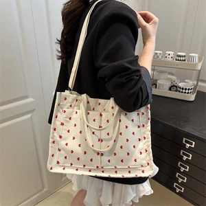 White corduroy tote bag with red heart patterns and detachable strap for women