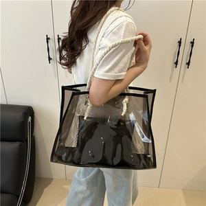 Minimalist transparent grey PVC tote bag with white rope handles worn by a model