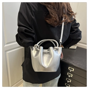 Close-up of metallic silver bucket bag with rope handle and BUPDA BAG FASHION logo