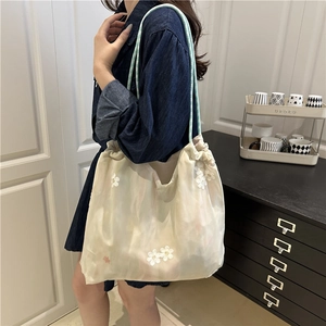 Chic off-white tote bag with daisy embroidery and blue braided rope handle for women