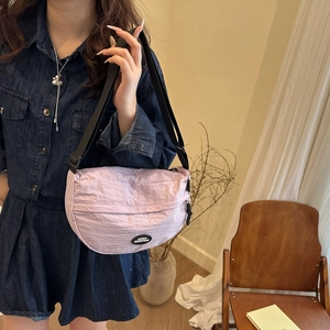 Light purple nylon crescent crossbody bag with adjustable strap and brand logo detail
