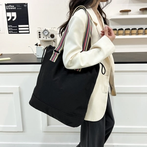 Summer black large tote bag with colorful striped wide shoulder strap for modern women