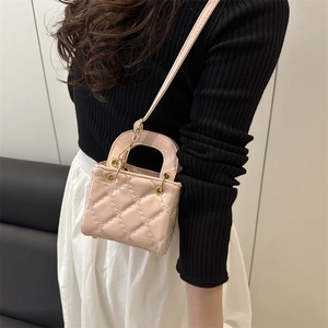 Pink quilted leather mini crossbody bag with round metal handles and classic pattern