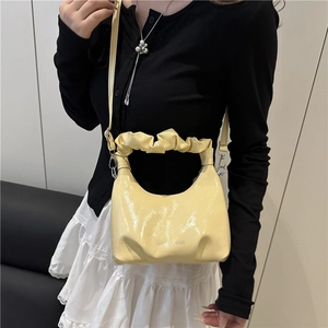 Fashionable light yellow bucket bag with pleated handle and adjustable shoulder strap