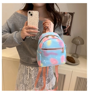 Detail of mini blue cloud backpack with heart logo and gold flower zipper pulls