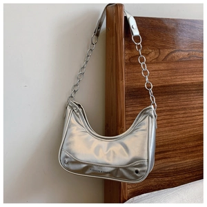 Detail of silver metallic hobo bag with rivet accents and silver chain shoulder strap