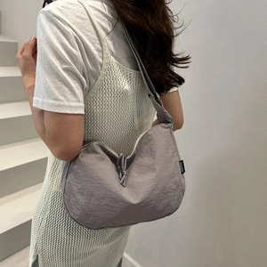 Minimalist grey-purple nylon crescent crossbody bag for women on clean white background