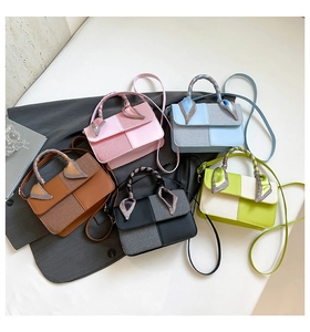 Top view of five stylish handbags with silk scarf handles in pink, blue, brown, black and green