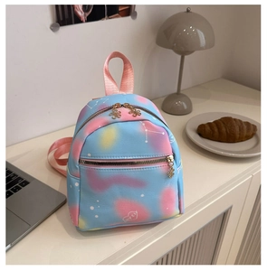 Detail of trendy gradient mini backpack with constellation patterns and flower zipper pull