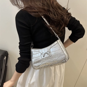 Silver crocodile texture shoulder bag with metal bow detail and sleek metallic finish