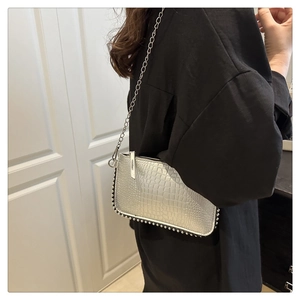 Detail of silver crocodile texture shoulder bag with studded trim and metal chain strap