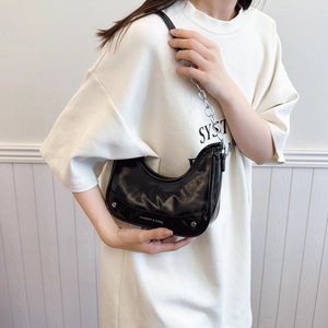 Fashionable black faux leather underarm bag with silver chain strap and rivet details