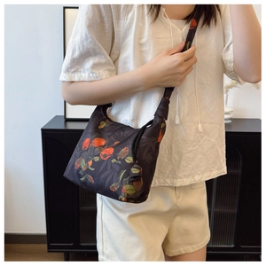 Detail of vintage Xiangyun silk crescent bag featuring traditional persimmon patterns