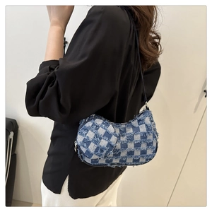 Detail of denim checkered crescent bag with frayed edges and matching coin purse