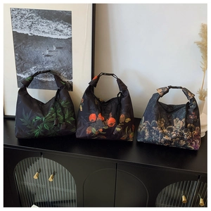 Detailed view of high-density fabric handbags with diverse floral and artistic prints