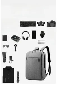Grey business backpack showing storage capacity for 15.6 inch laptop and accessories