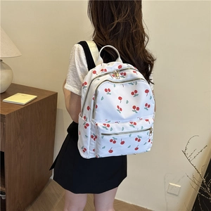 White casual backpack with red cherry print and gold zippers for women's travel use