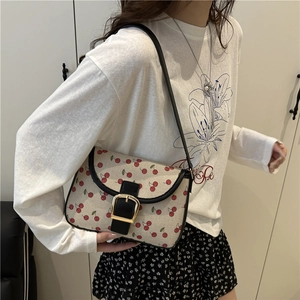 Cute cherry print small handbag with cream canvas, black leather trim and gold buckle