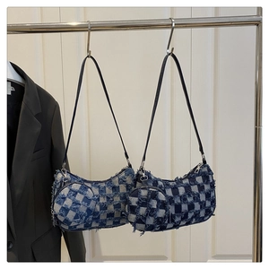 Close-up of checkered denim crescent bags with fringe detail and mini coin pouches