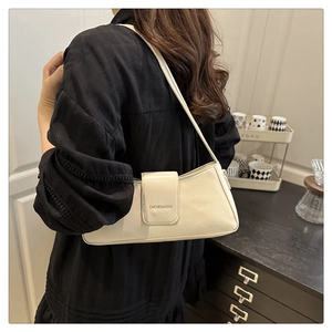 Close-up of minimalist beige leather underarm bag with CAICHENJIABAG logo branding