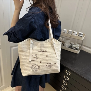 Large beige woven straw tote bag with brown cat embroidery for seaside beach holidays
