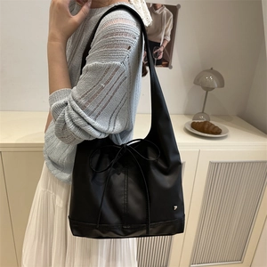 Minimalistische schwarze PU-Leder Achseltasche mit Schleife und Herzlogo am Modell
