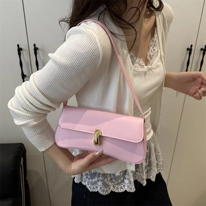 Elegant light pink baguette shoulder bag with glossy leather and gold buckle for women