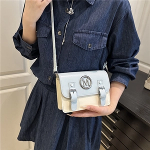 Minimalist rectangular crossbody bag with blue flap and white body on female model