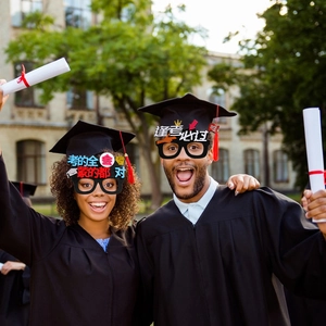 Detail of graduation glasses with motivational text worn by students in robes