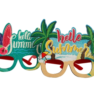 Detail of Hello Summer party glasses with colorful glitter, palm trees and surfboard