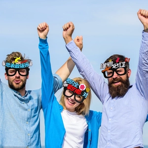 Close-up of students wearing black party glasses with Chinese motivational exam slogans
