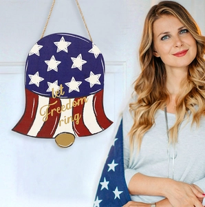 Close-up of let freedom ring wooden bell decoration with stars and stripes design