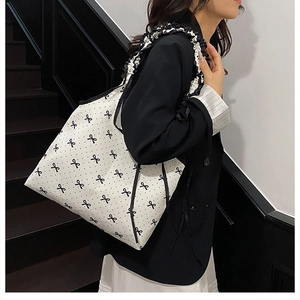Detail of the large tote bag with polka dots, bows, and ruffled decorative shoulder strap
