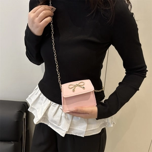 Pink mini crossbody bag with golden bow hardware and chain strap for women