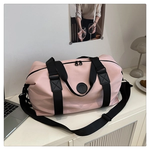 Pink travel tote bag with reinforced handles and adjustable strap for sports or commute