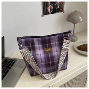 Detail of purple checkered canvas tote bag with adjustable geometric shoulder strap